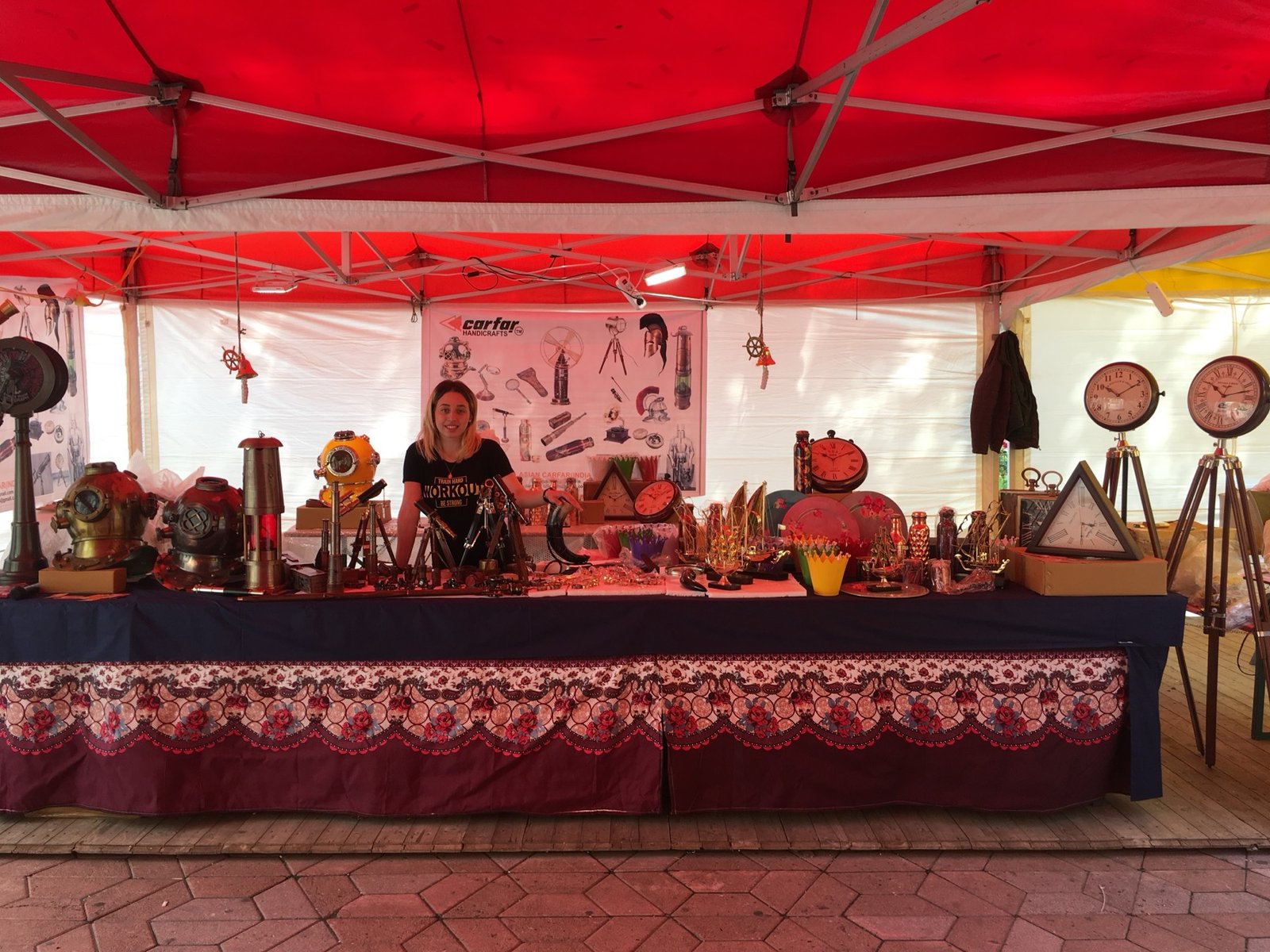 Vintage clocks and brass pieces laid out at the fair